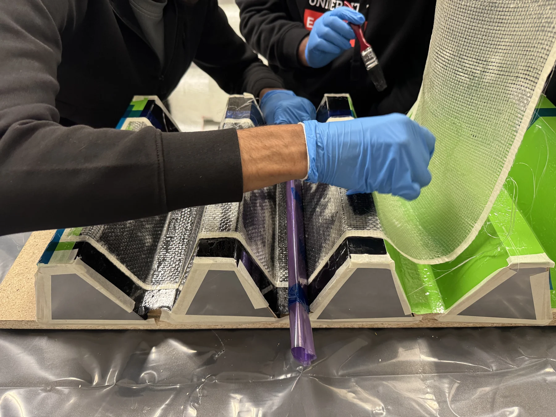 Hands-on composite fibre layup in the workshop.